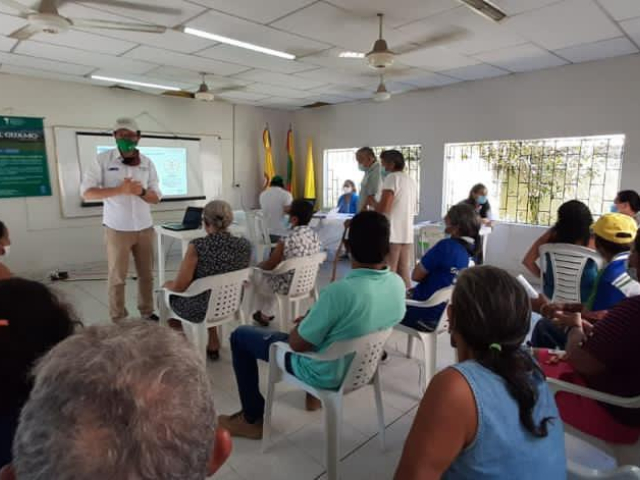 En la fotografía aparece un funcionario de la ANT dando una exposición a futuros propietarios de predios en el Guamo, Bolívar. 