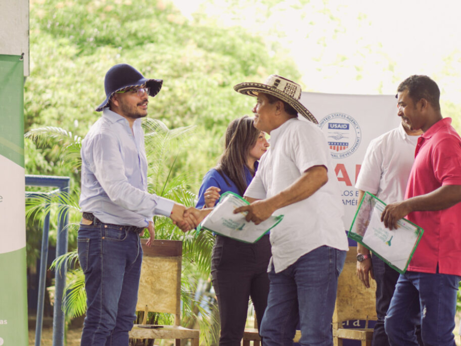 Funcionario haciendo entrega de los títulos.